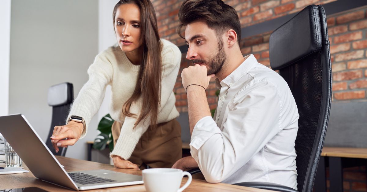 HR consultant guiding a business leader through leadership development strategies on a laptop.