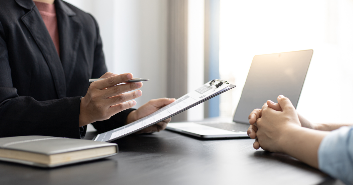 HR consultant reviewing documents with a client during a fractional HR consulting session.